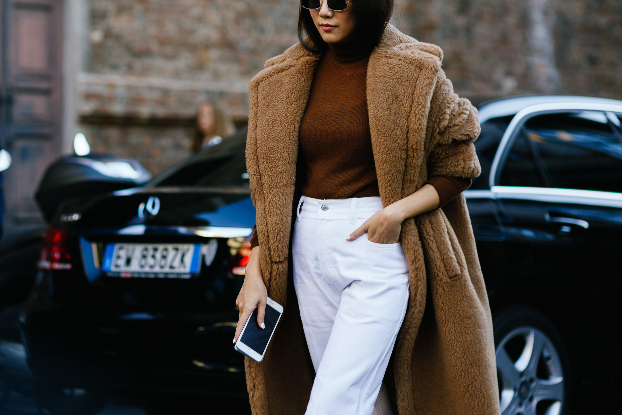 Yoyo Cao wearing white jeans and Max Mara camel teddy coat in Milan, Italy