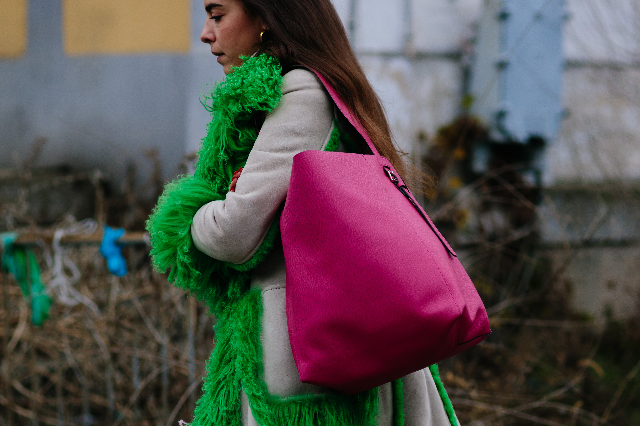 Greek editor wearing green coat and pink bag