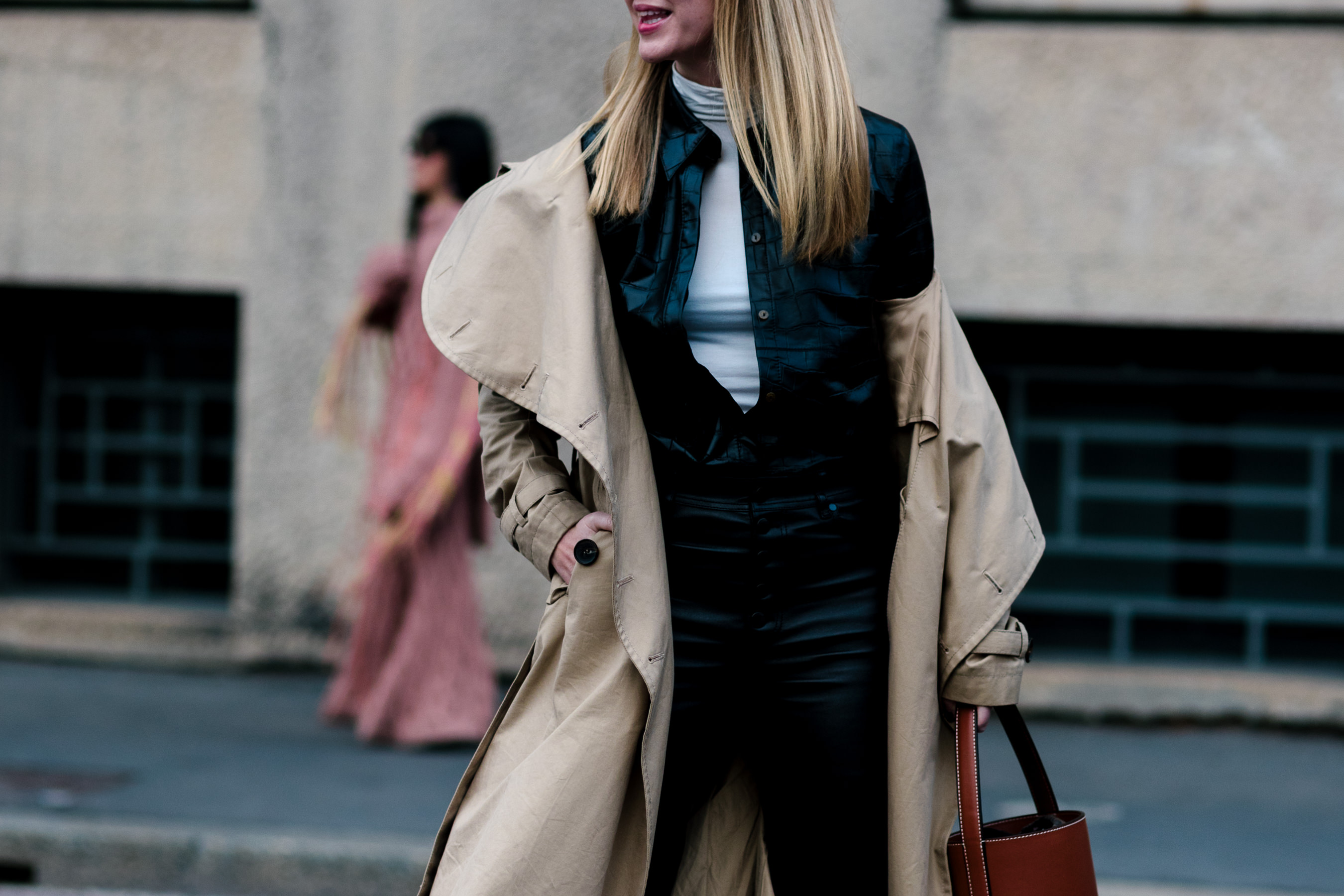 woman wearing leather jumpsuit and trench coat