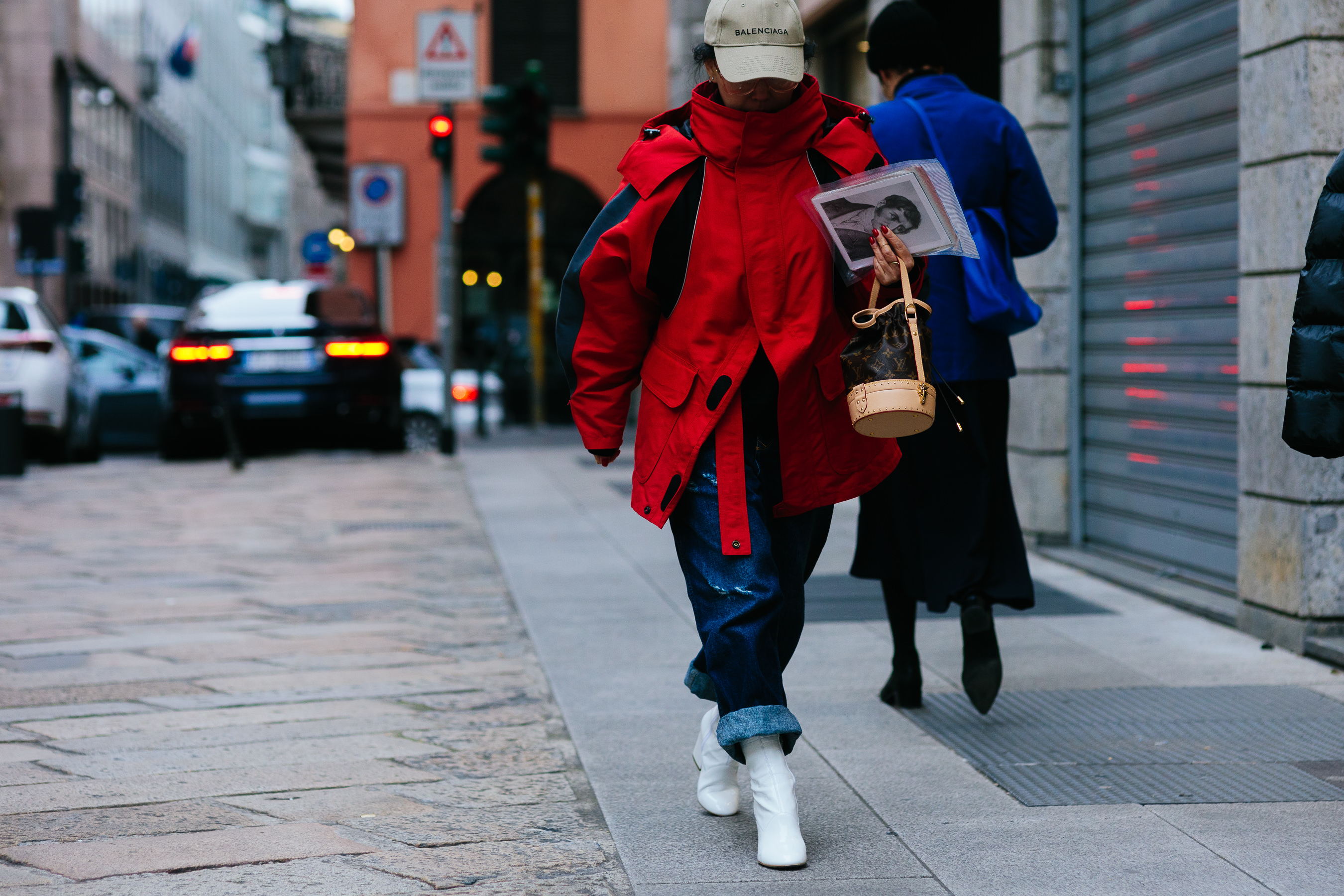 woman wearing Balenciaga jacket and hat