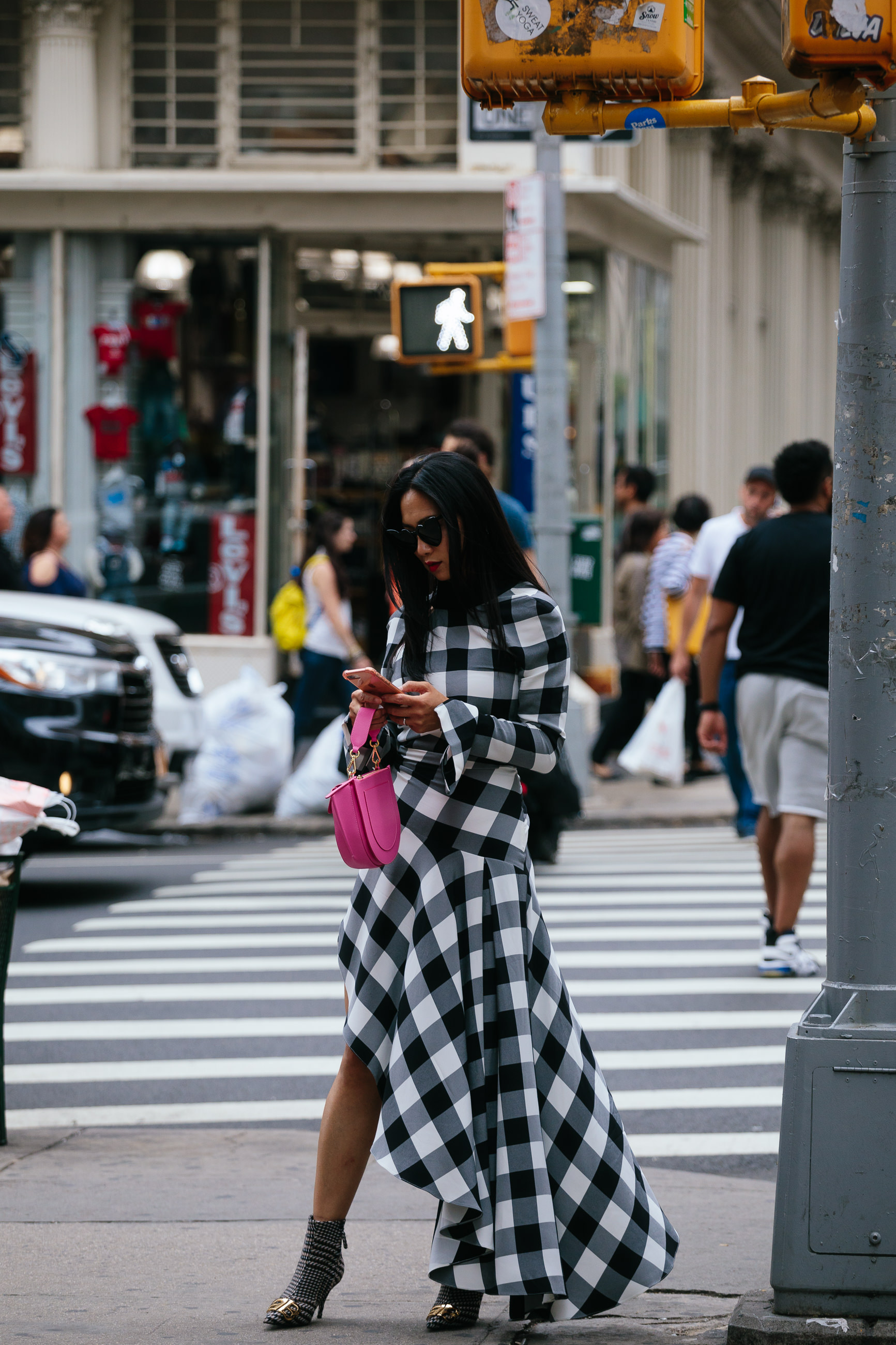 woman wearing checked dress pink bag in NYC