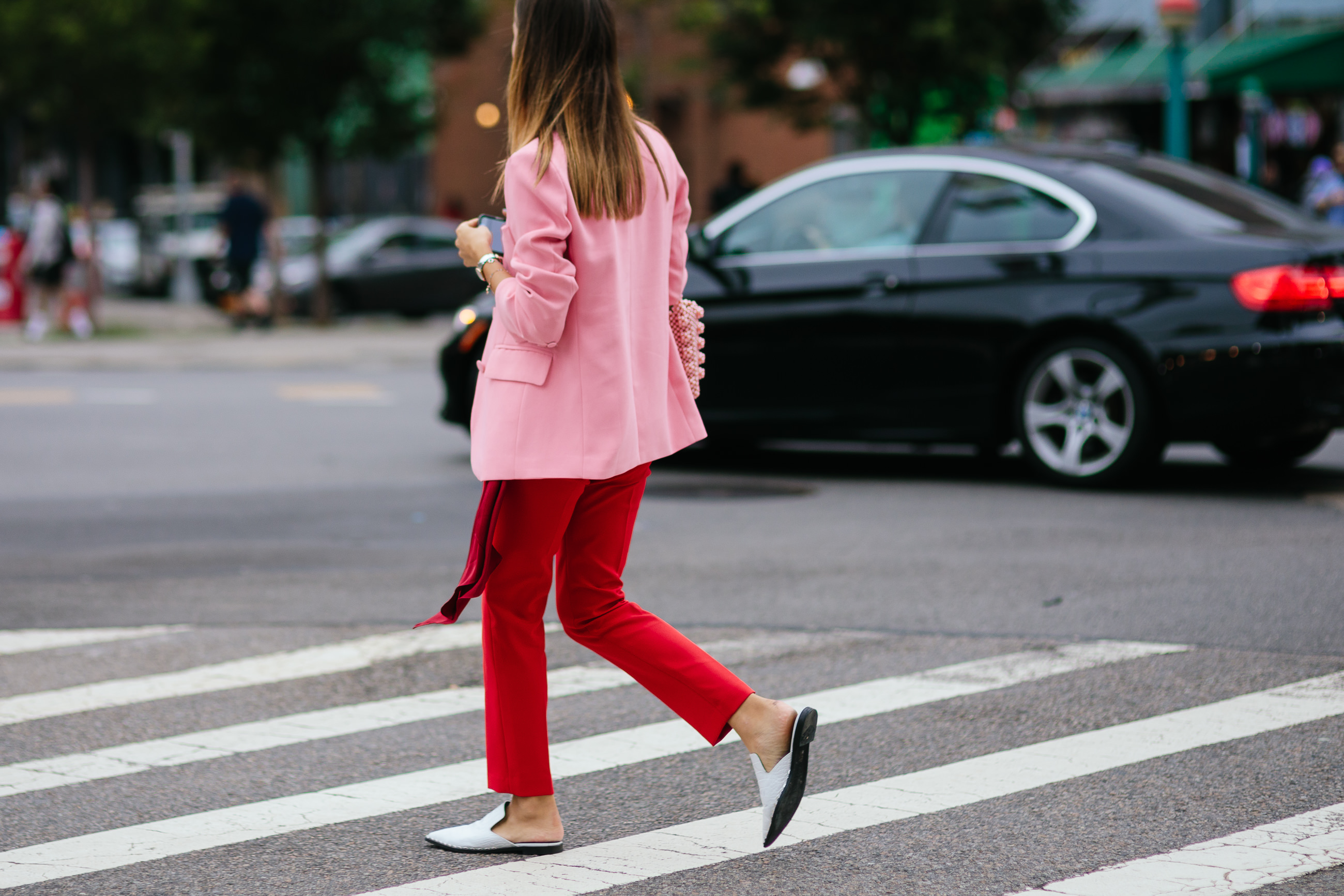 woman wearing red pants pink blazer in NYC